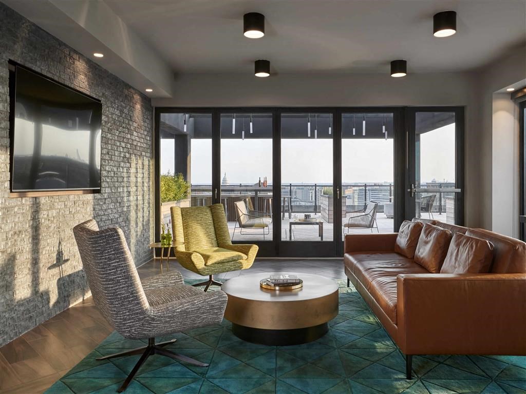 a living room with couches and chairs and a television