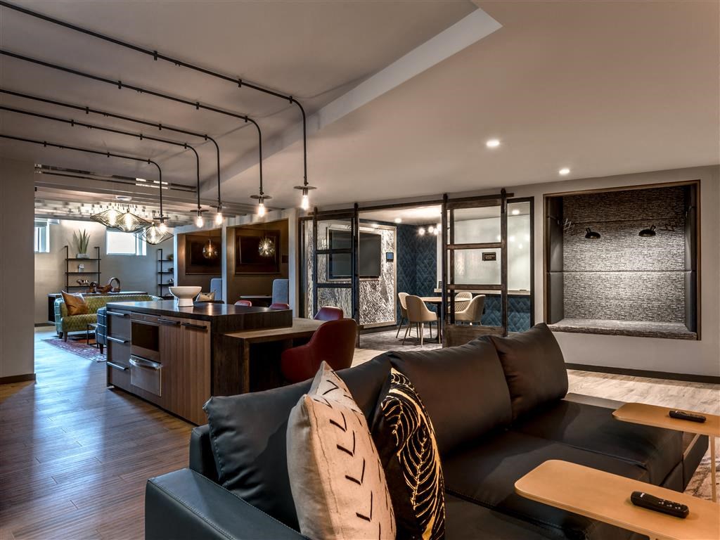 a living room with a couch and a kitchen