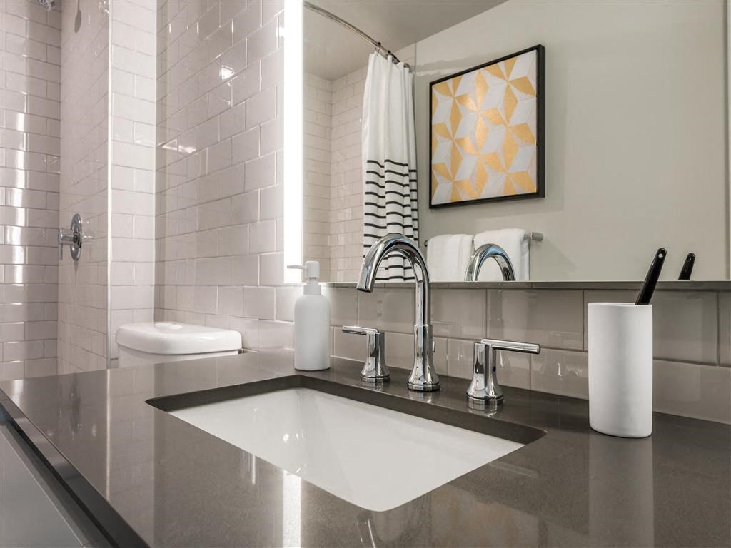 a clean bathroom with a sink and a mirror