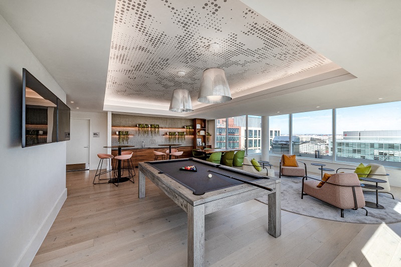 a living room with a pool table in the middle