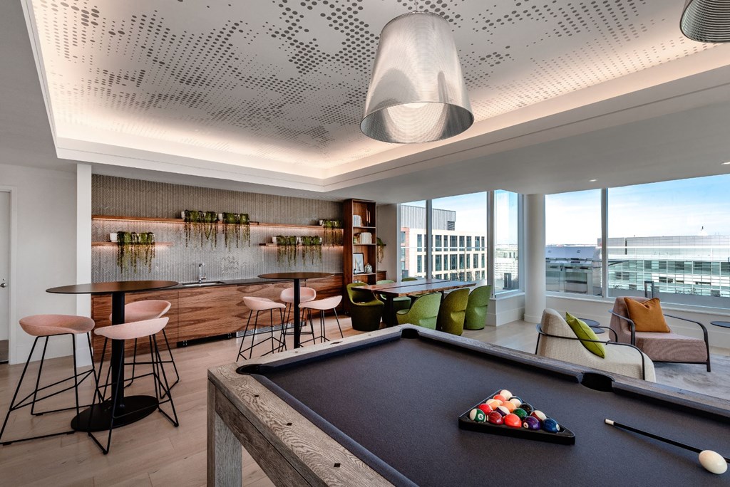 a game room with a pool table and a bar