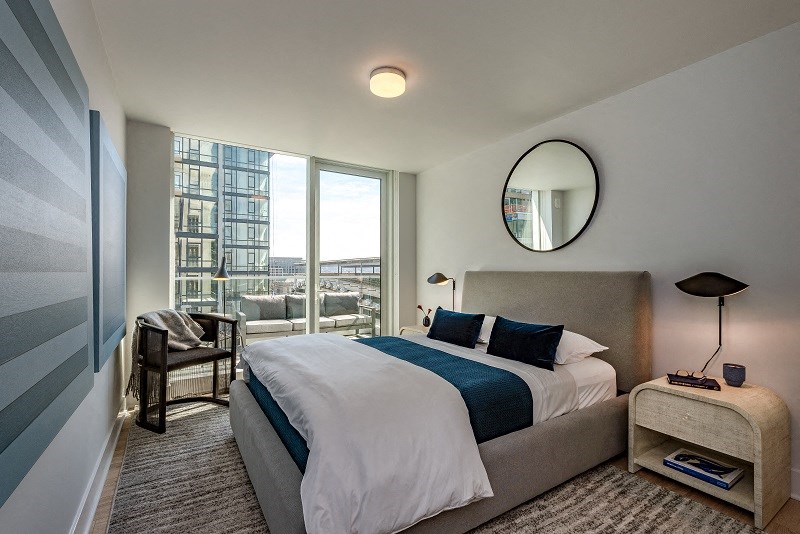 a bedroom with a bed and a large window