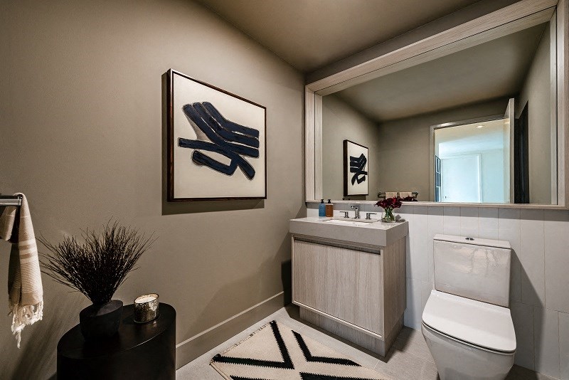 a bathroom with a toilet and a sink and a mirror