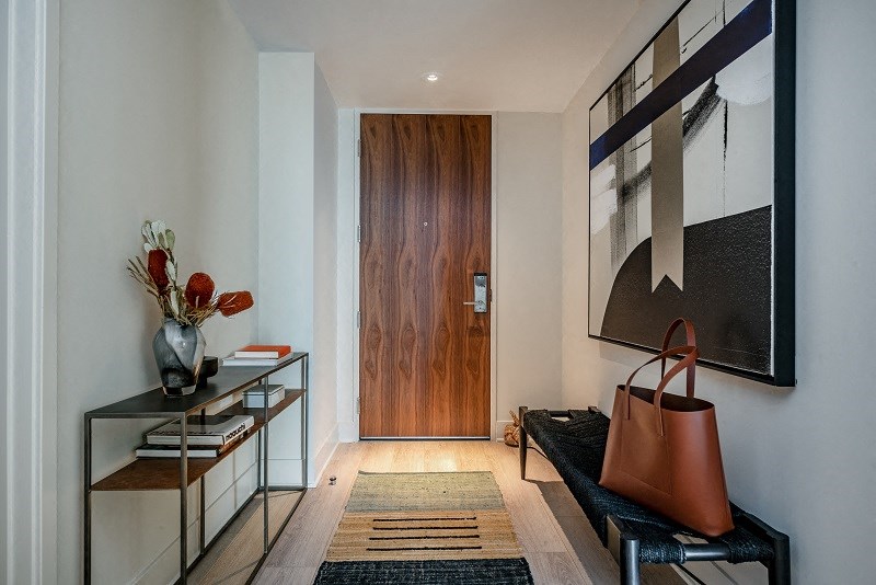 a living room with a couch and a wooden door