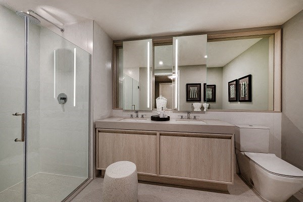 a bathroom with a toilet and a sink and a shower