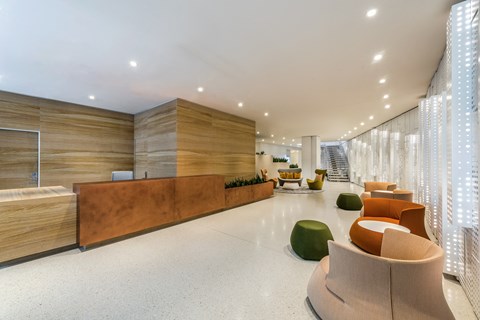 a lobby with chairs and a reception desk