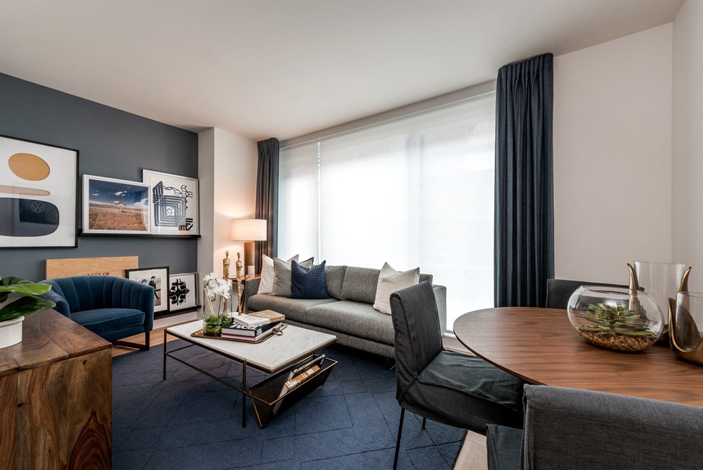 a living room with a couch and a table and a window