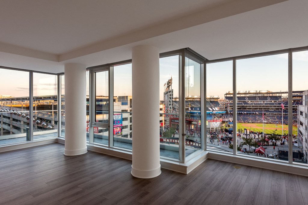 a view of a stadium from a living room with glass windows