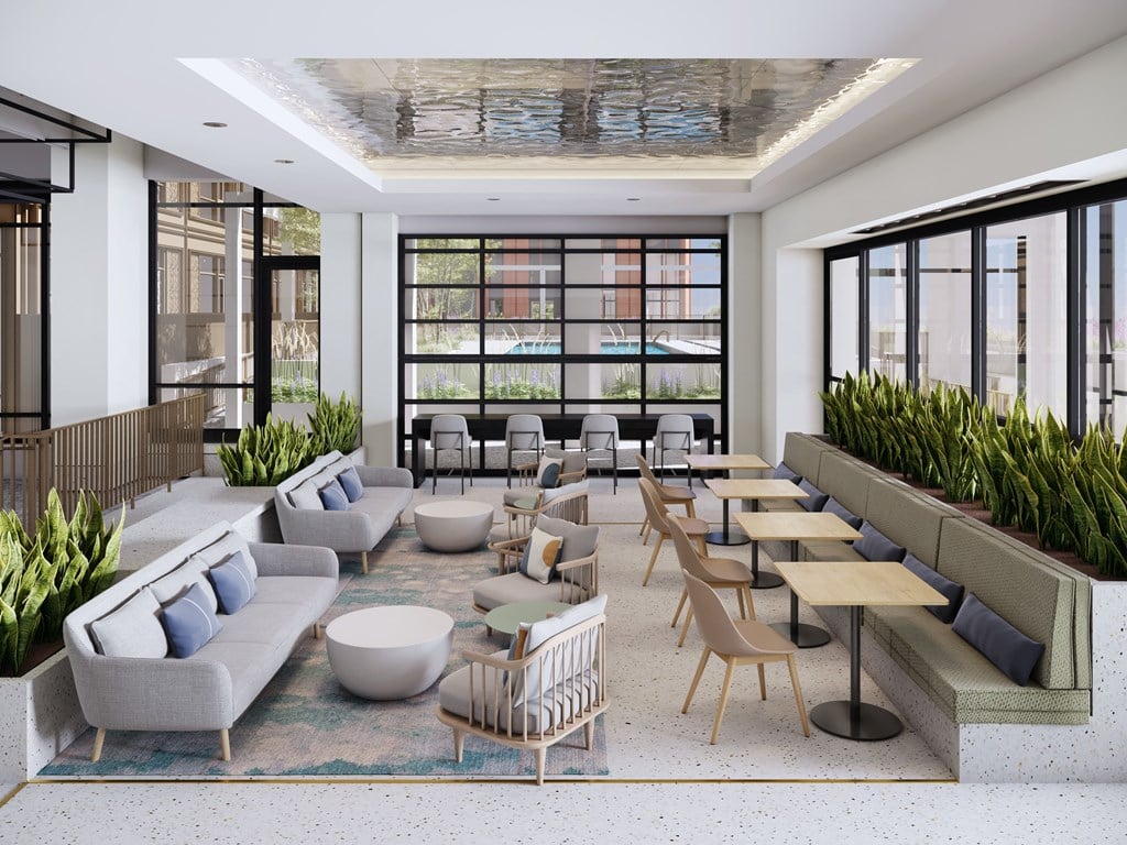 a rendering of a lobby with couches and tables and windows