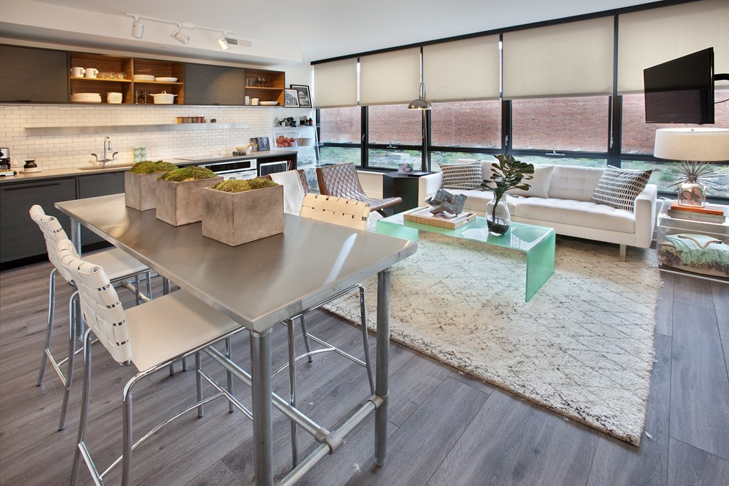 a dining room and living room with a table and chairs