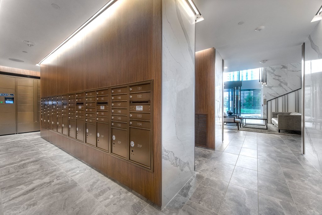 a view of the lobby of a building with mailboxes and marble floors