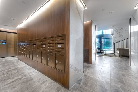 a view of the lobby of a building with mailboxes and marble floors