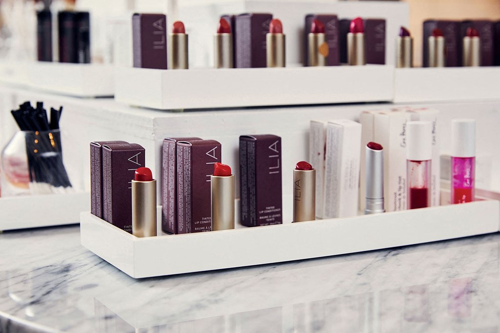 a row of cosmetics and books on a counter