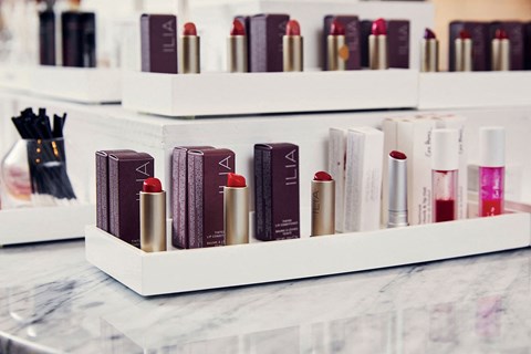 a row of cosmetics and books on a counter
