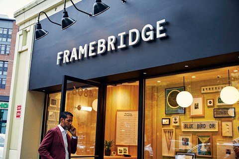 a man talking on his cell phone outside of a store