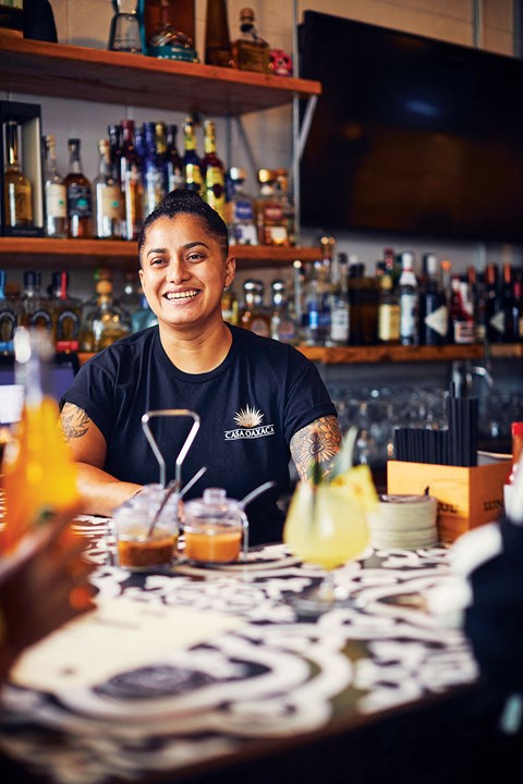a man sitting at a bar with a drink