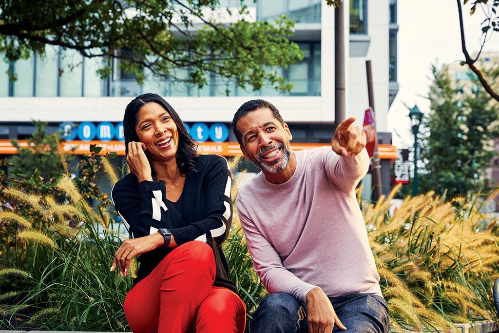 a man and a woman sitting in the grass