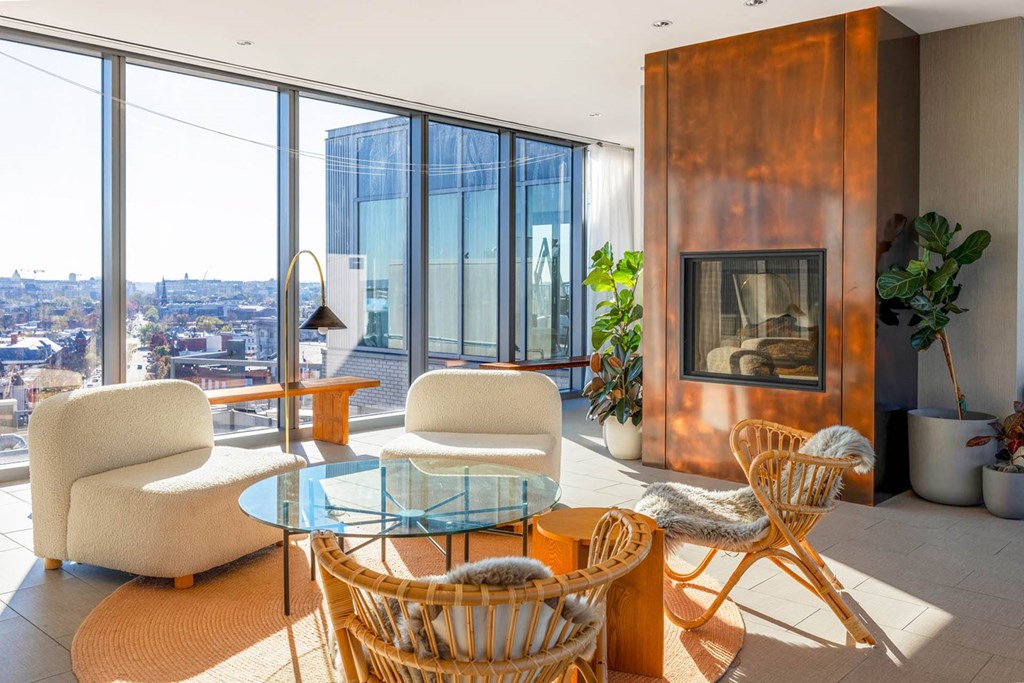 a living room with a fireplace and a table and chairs