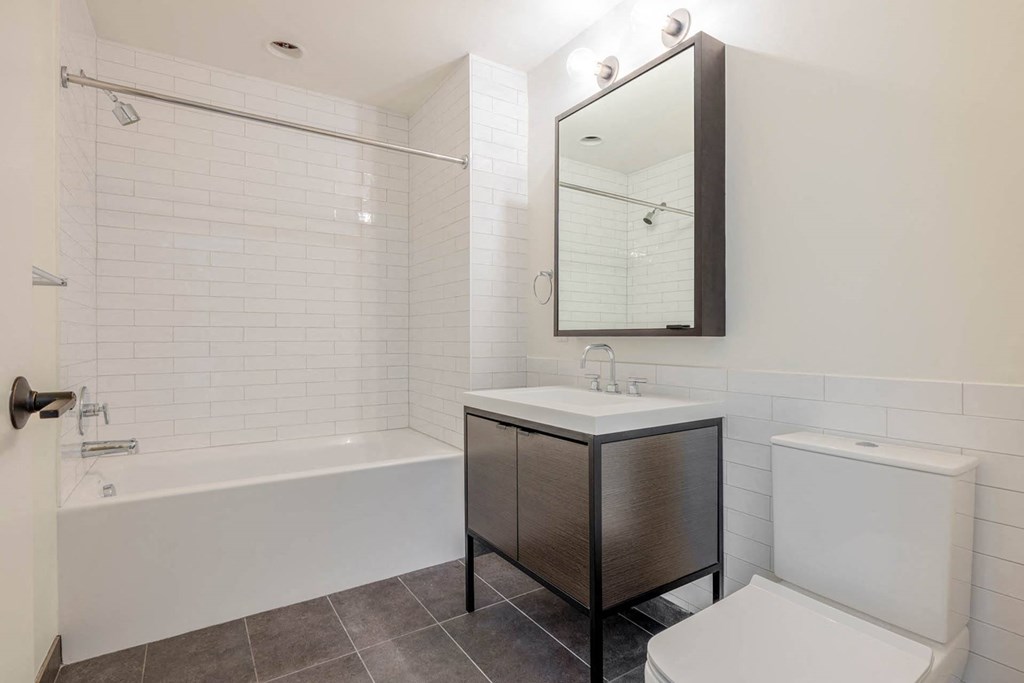 a bathroom with a sink and a tub and a toilet