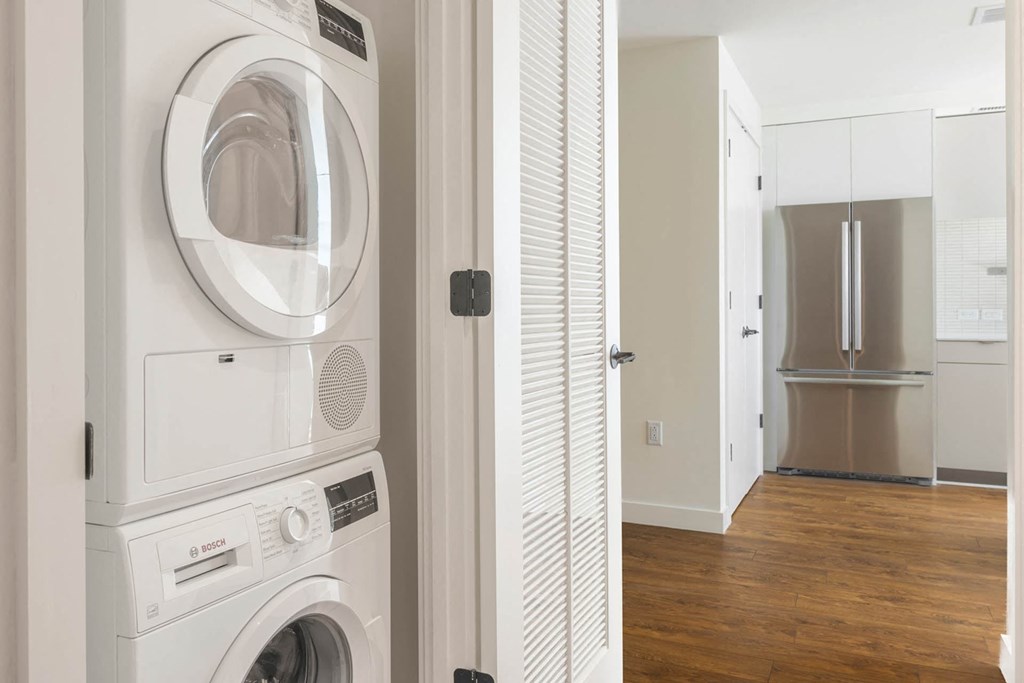a white laundry room with a washing machine and a dryer