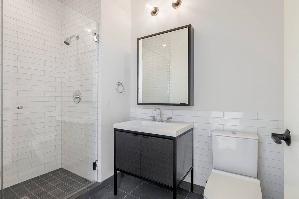 a white bathroom with a sink and a mirror