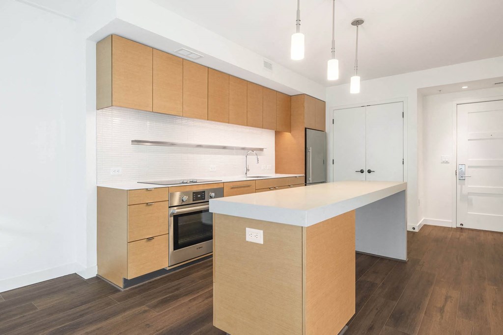 a kitchen with wooden cabinets and a white counter top