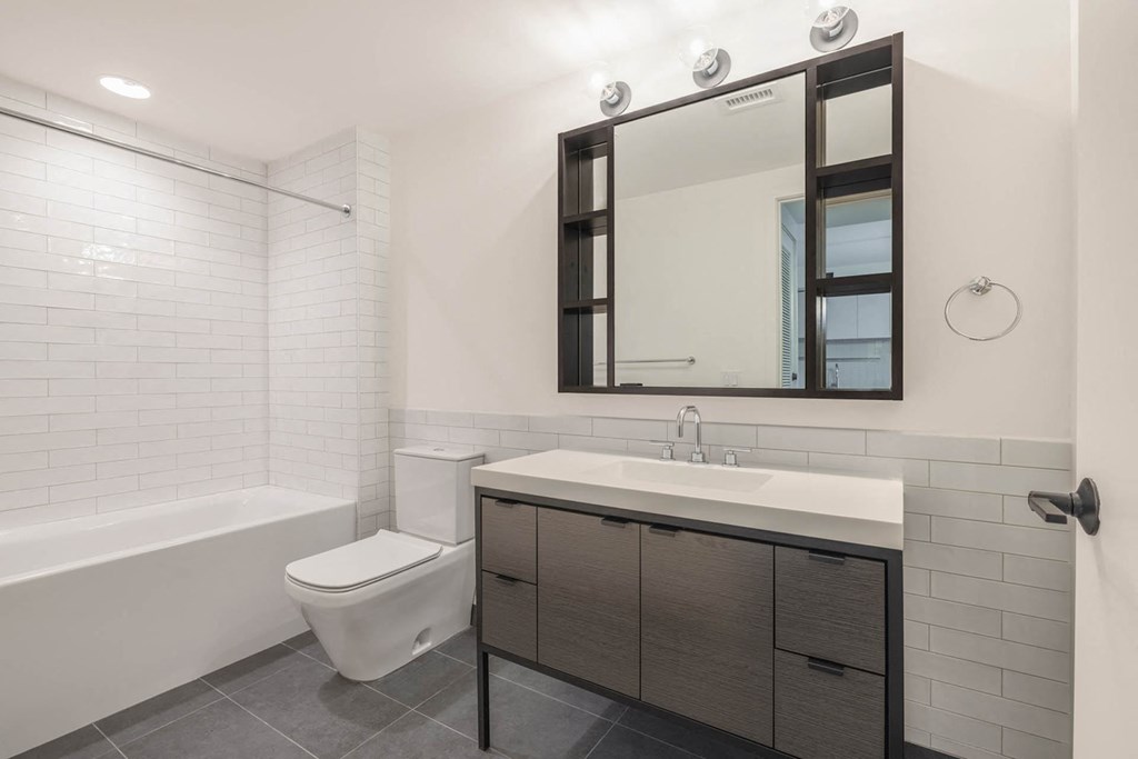 a bathroom with a sink and a toilet and a mirror