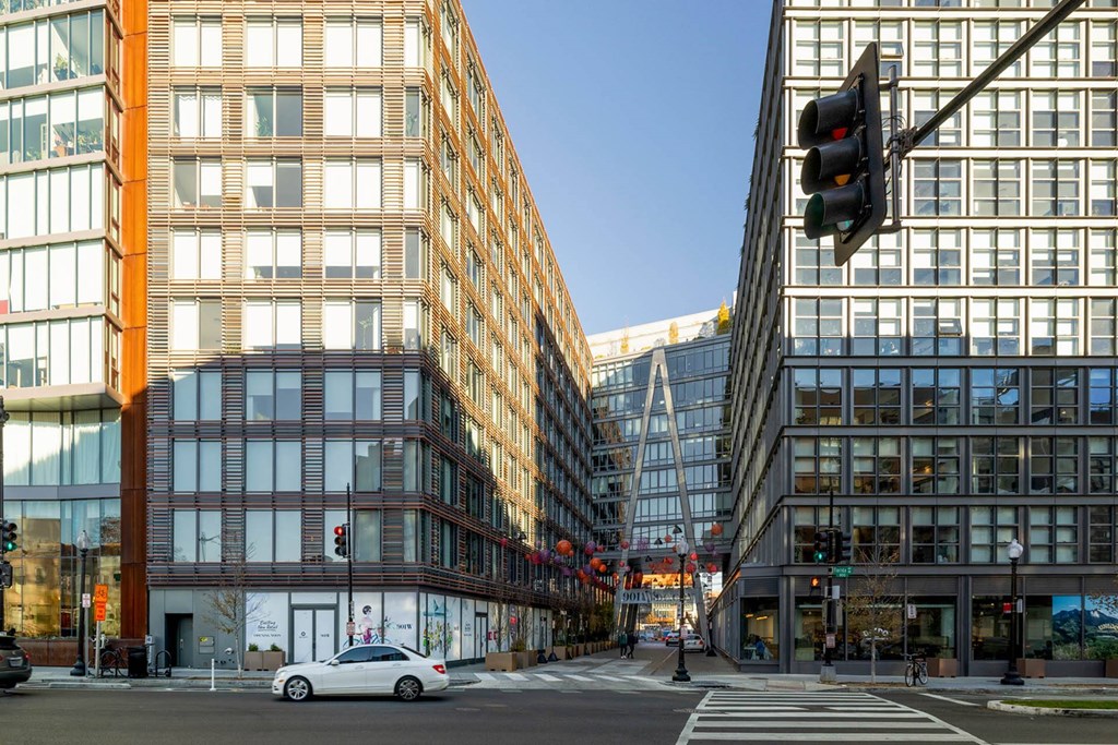 a city street with tall buildings and a traffic light