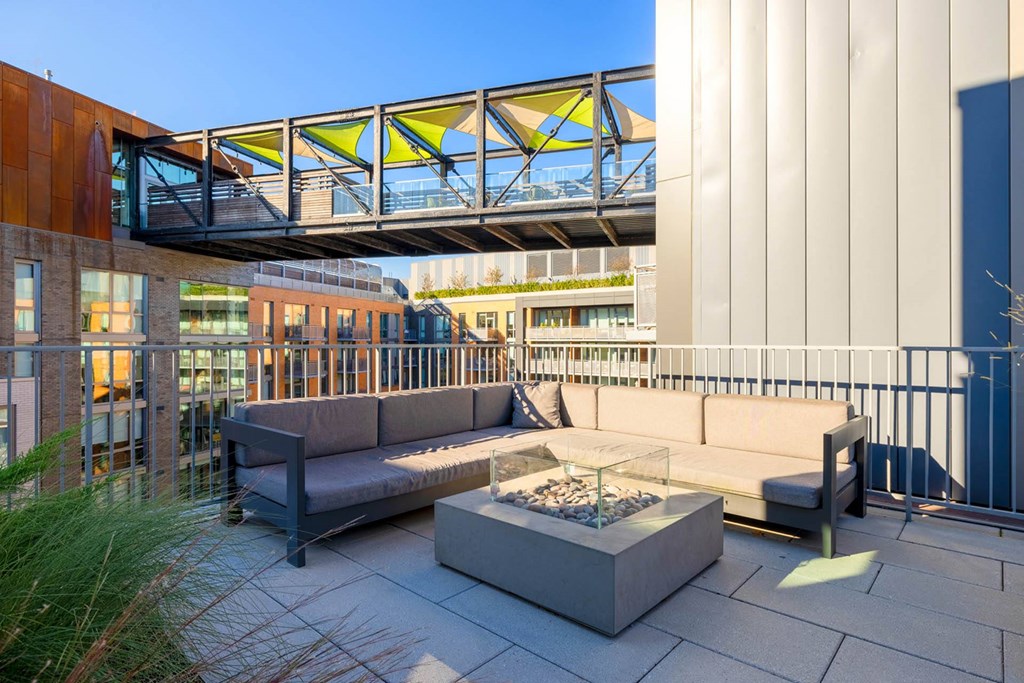 a patio with a couch and a coffee table on a balcony