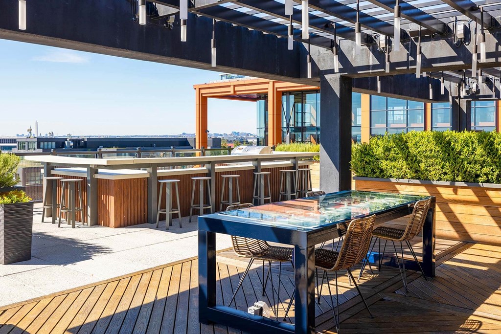 a rooftop bar with a table and chairs on a roof