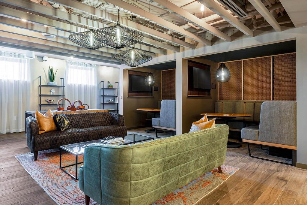 a living room with couches and chairs and a television