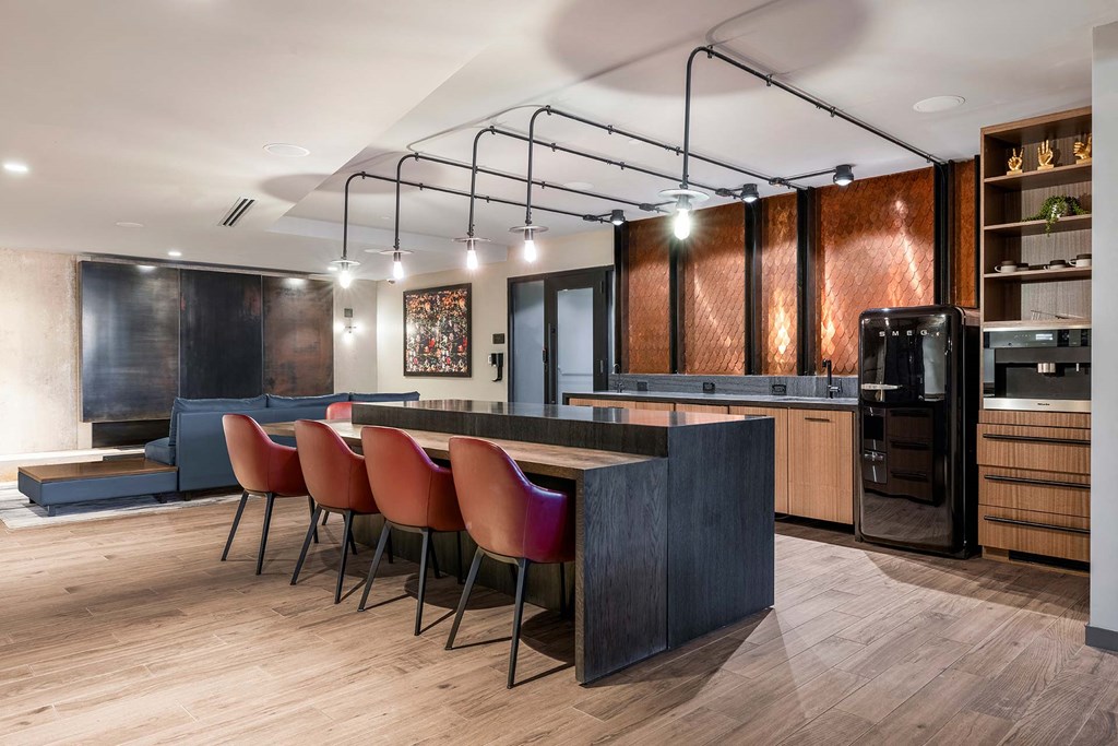 a kitchen and living room with a table and chairs
