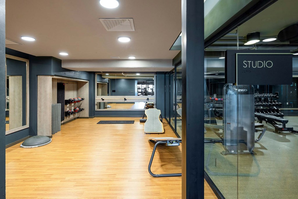 a gym with a wooden floor and a yoga studio