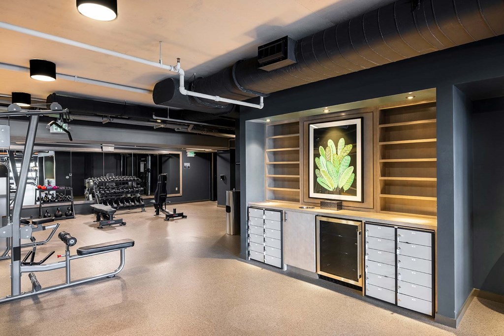 a workout room with weights and other equipment in a gym