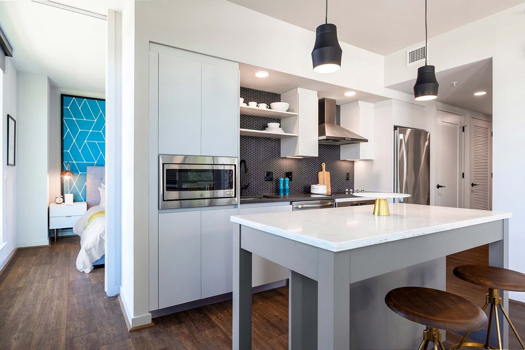 a kitchen with a white counter top and a refrigerator