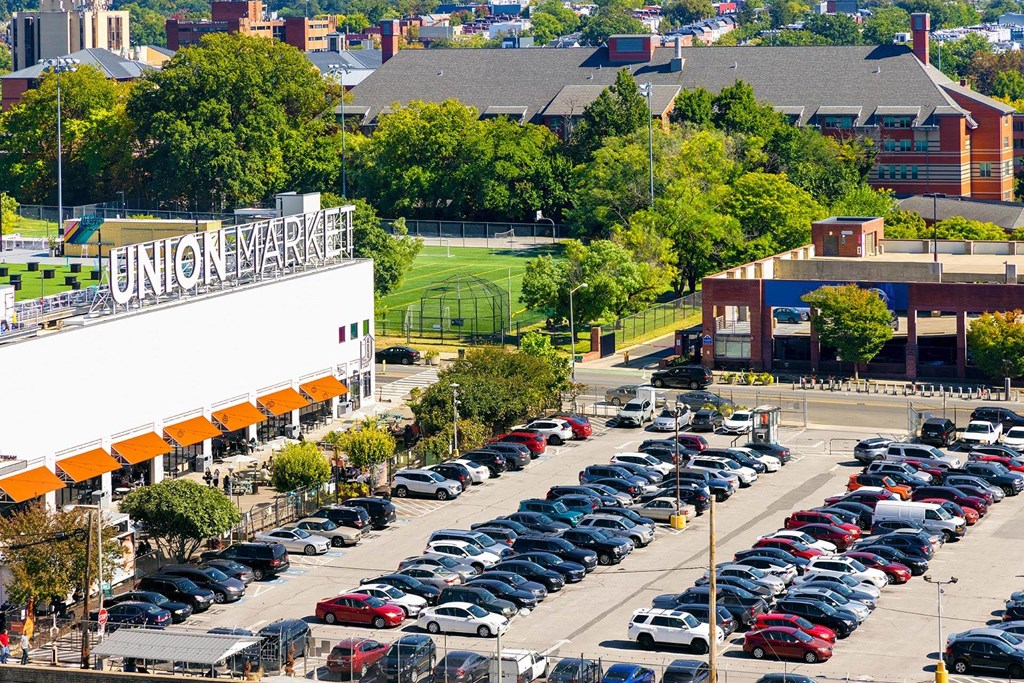 a parking lot filled with cars in front of a building