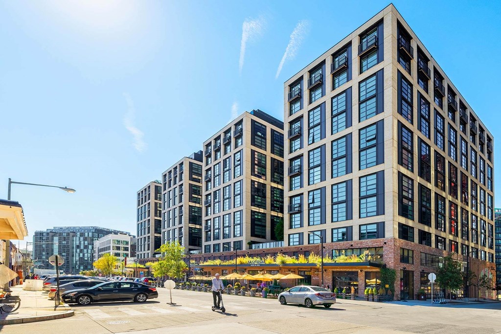 a rendering of a new apartment building on the corner of a city street