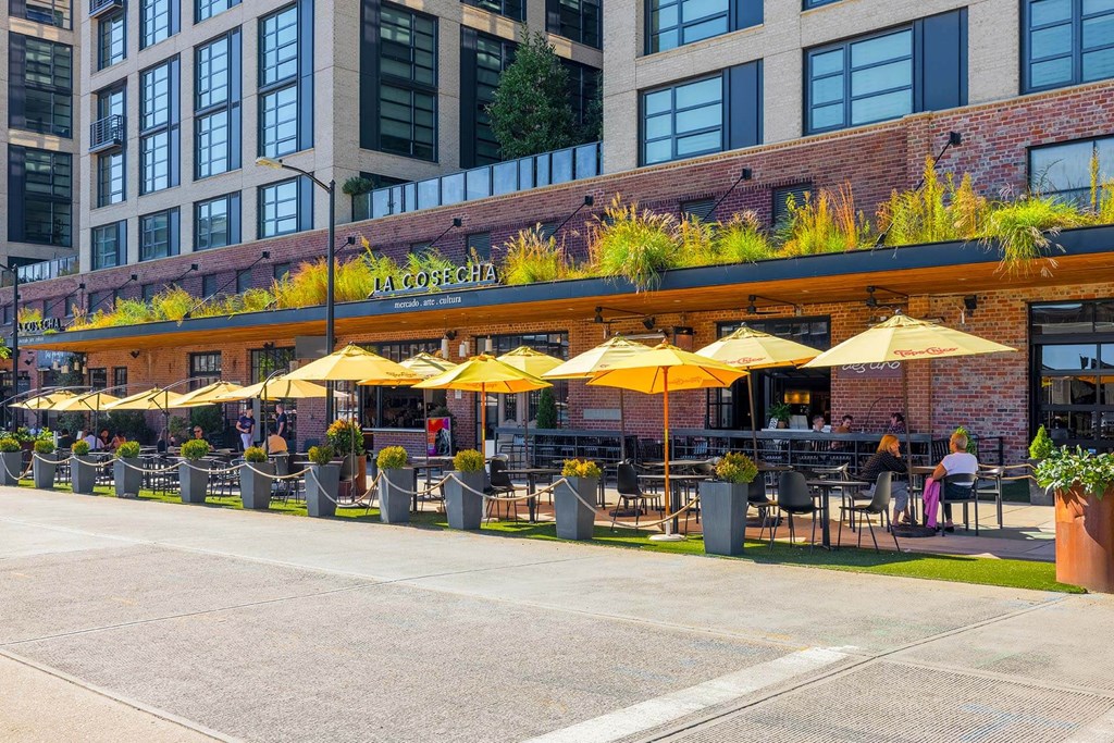 a rendering of the outside of a restaurant with yellow umbrellas