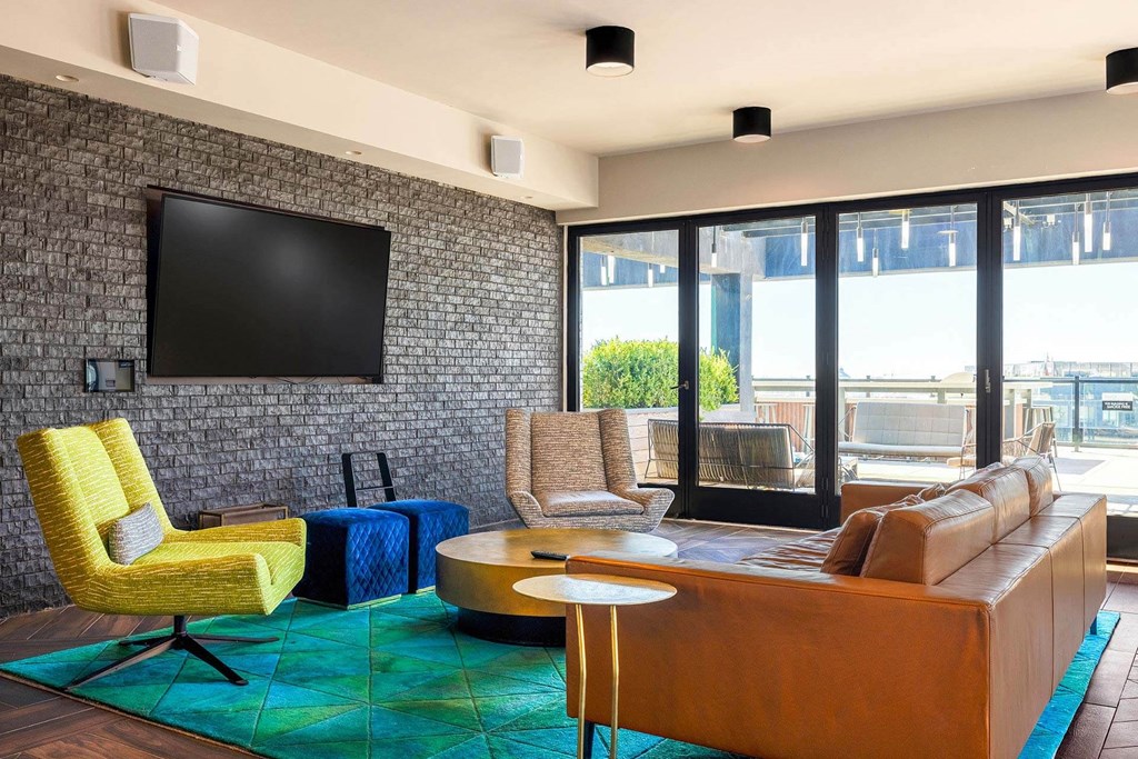 a living room with a couch and chairs and a television