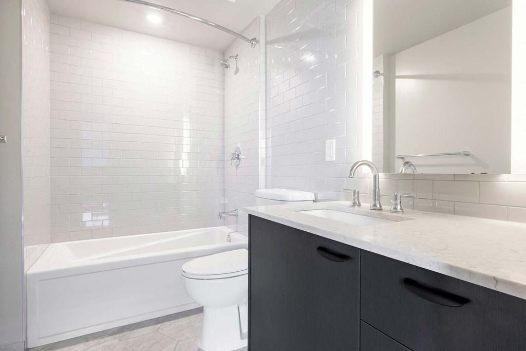 a white bathroom with a sink and a toilet