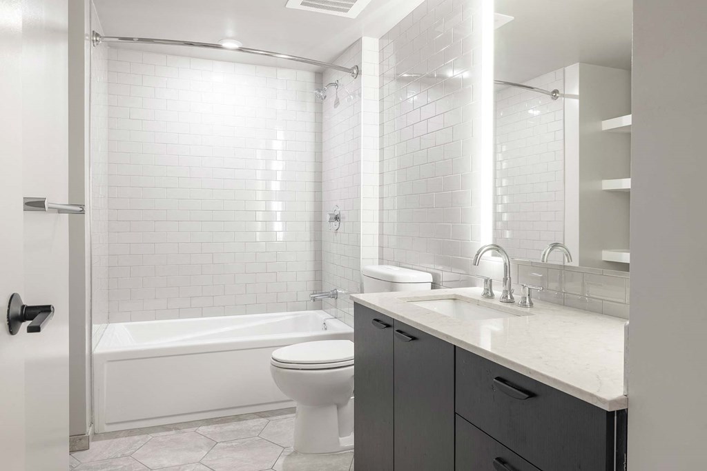 a white bathroom with a sink and a toilet
