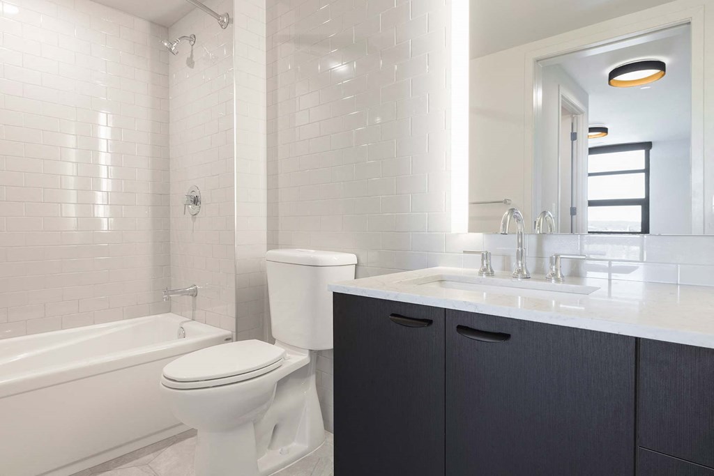 a white bathroom with a toilet and a sink