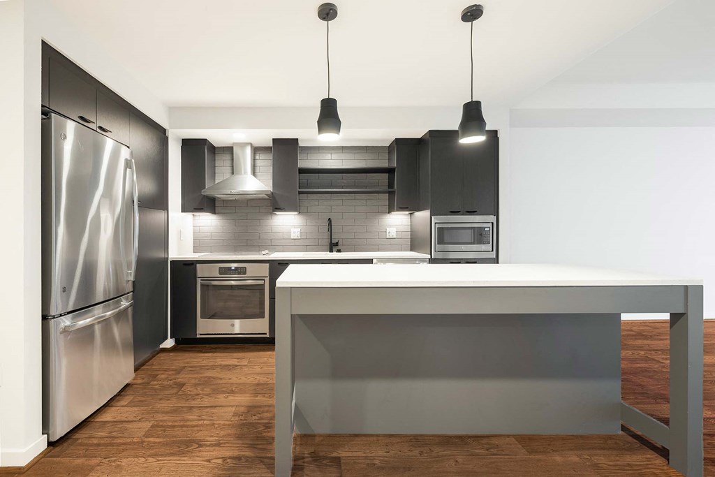 a kitchen with stainless steel appliances and a white counter top