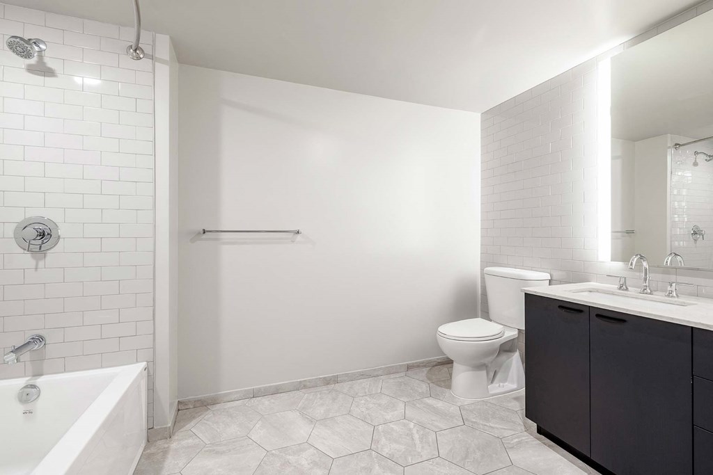 a white bathroom with a toilet and a sink