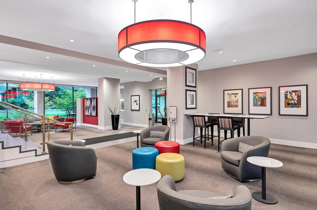 A modern waiting room with a variety of seating options and a large window.