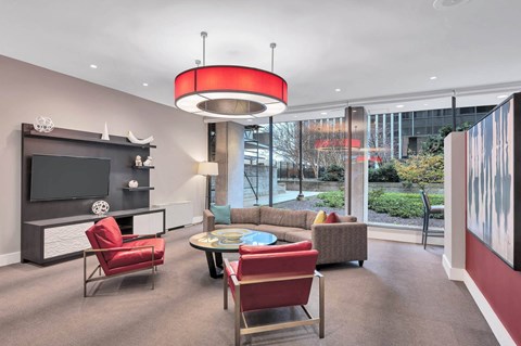 a living room with a couch and chairs and a television