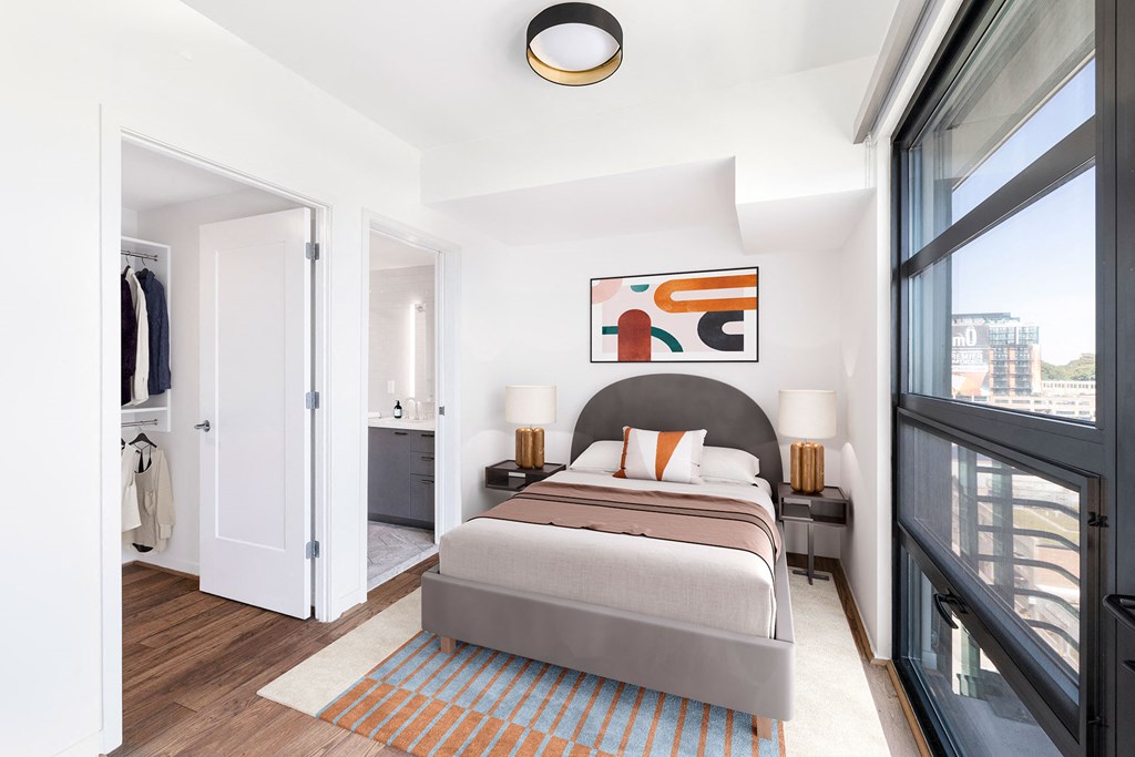 a bedroom with a large bed and a large window