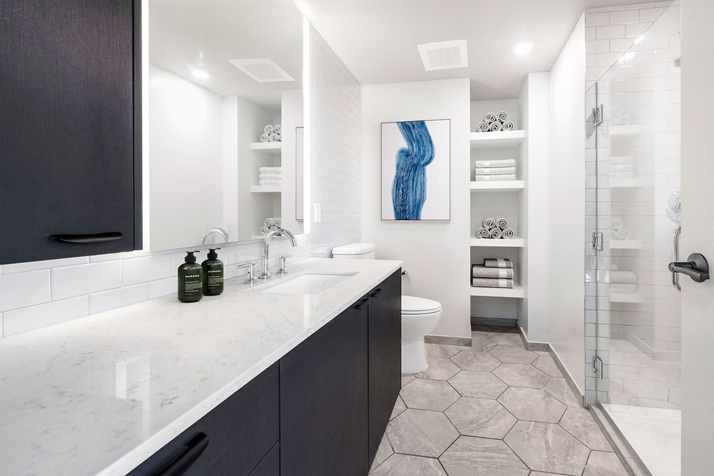 a bathroom with a sink toilet and shower