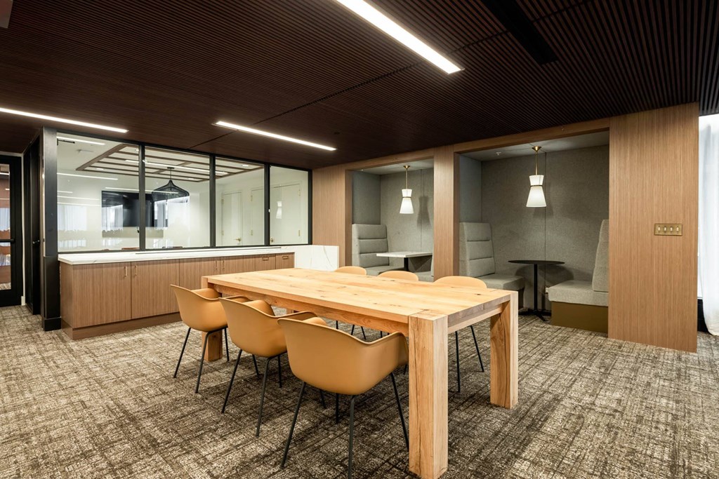 a conference room with a wooden table and chairs