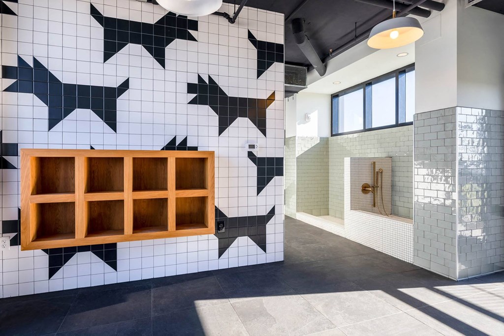 a tiled wall with a window and a shower